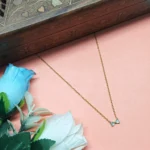 Graceful CZ Gold-Tone Bow Pendant