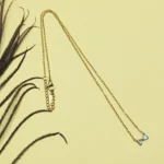 Graceful CZ Gold-Tone Bow Pendant
